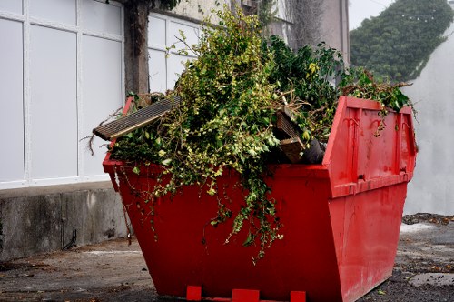 Workers segregating office waste into recycling and reuse streams